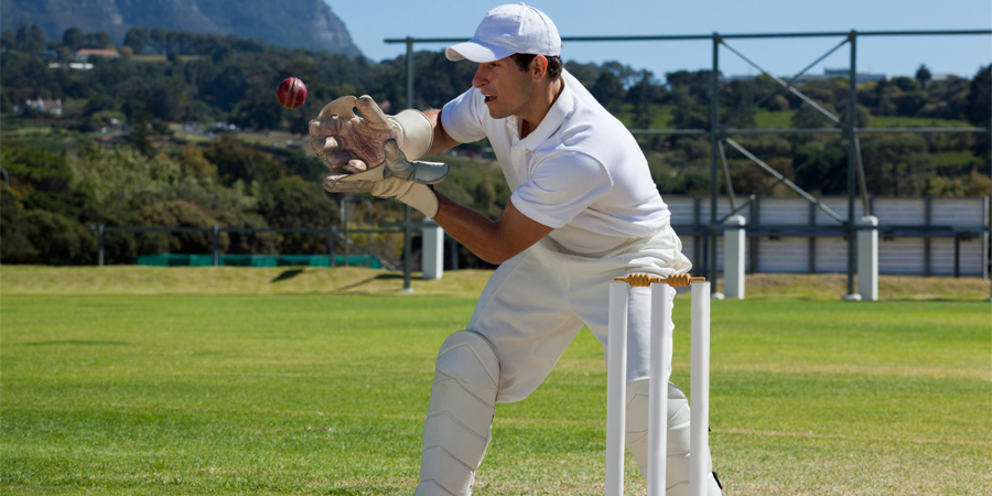 cricket bowler catching ball