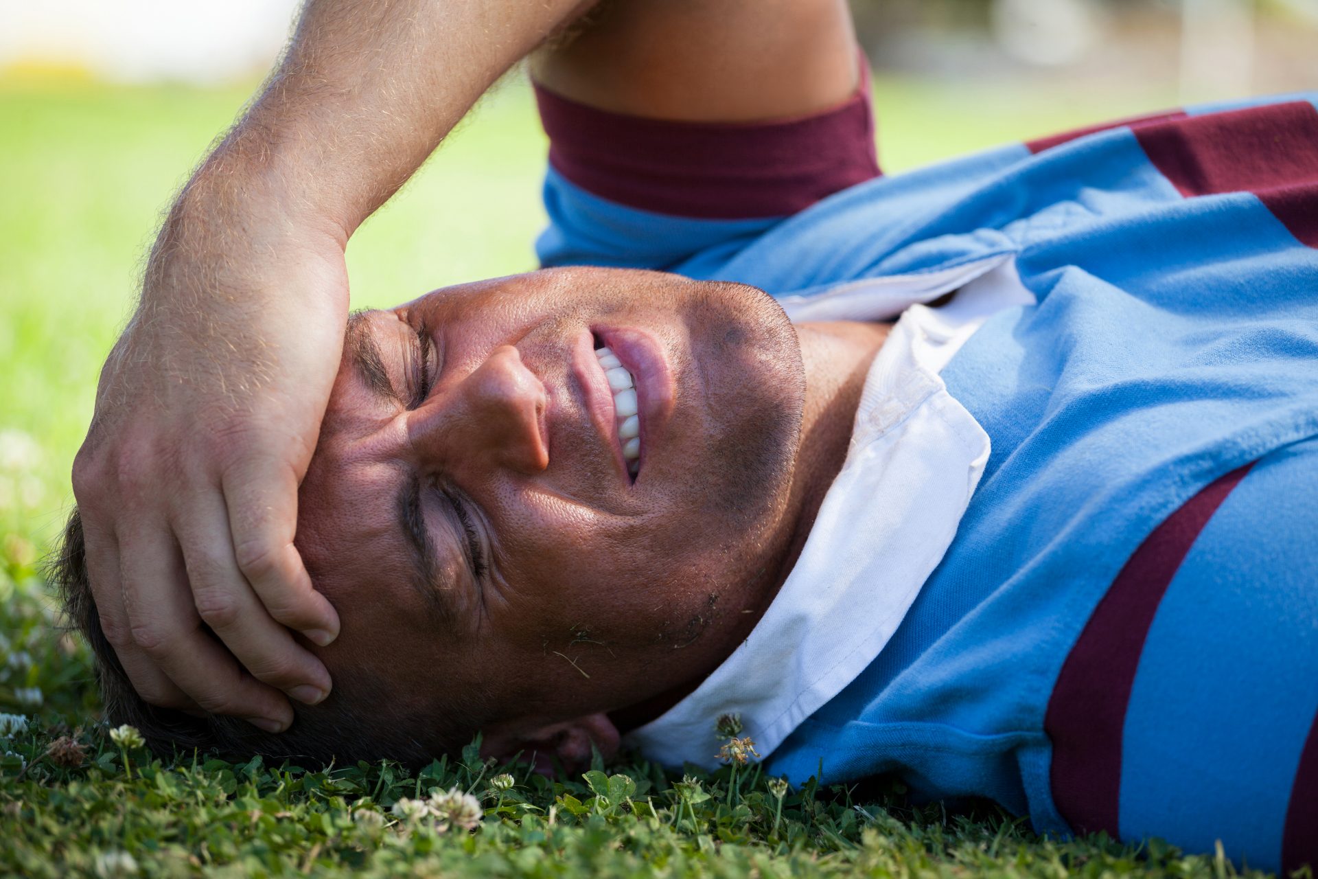 injured rugby player with eyes closed lying on fie 2026 03 25 05 13 18 utc injured football player with eyes closed lying on field
